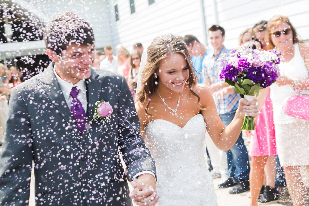 bride and groom exiting church thru lavender
