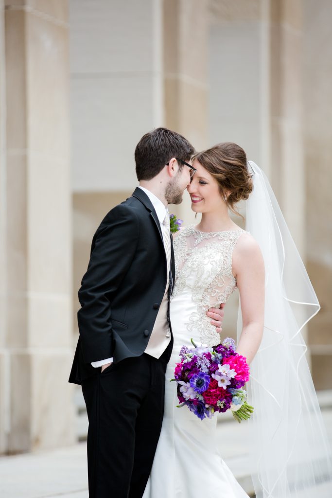 groom telling bride secret on stairs